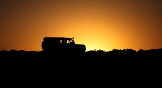 &quot;Image of a self-drive adventure in Botswana, showcasing a rugged 4x4 vehicle traversing the dusty and scenic landscapes of Botswana. The endless horizon, vast plains, and a sense of independence capture the essence of an epic self-guided safari.